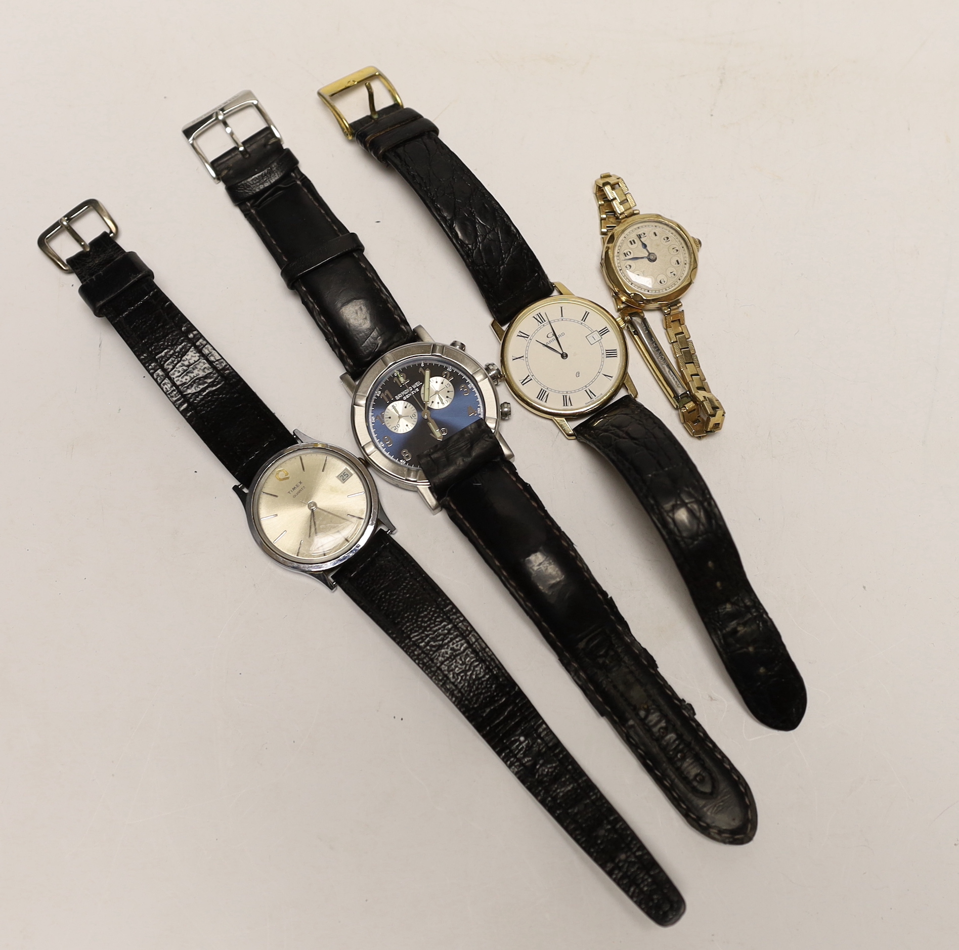 Three assorted gentleman's wrist watches including Raymond Weil, Timex and a 9ct gold quartz wrist watch, retailed by Garrard, together with a lady 9ct gold manual wind wrist watch, on steel and gold plated bracelet.